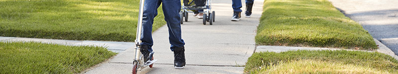 a family using a sidewalk in a neighborhood